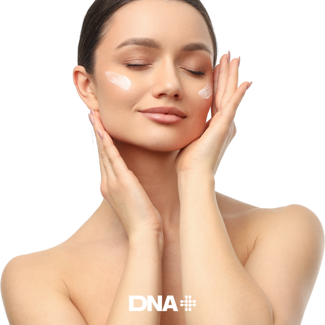 Woman applying cream to her face with a white background, featuring the DNA PLUS logo.